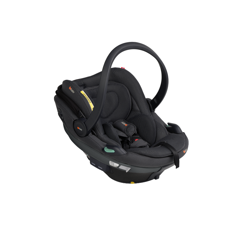 Schwarze Babyschale mit Tragegriff, gepolsterter Liegefläche und integriertem Gurtsystem in schräger Seitenansicht.